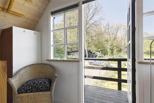 a room with a chair and a large window at 5544-Gudhjem-Badstadvej-14 in Gudhjem