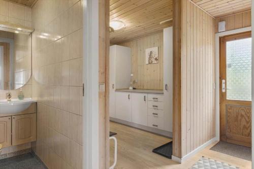 a bathroom with a sink and a mirror at OH369-Hadsund-Fjordglimt-4 in Hadsund