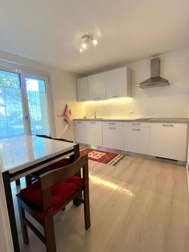 an empty kitchen with a table and a chair at Casa vacanze Ai Denat in Lamon
