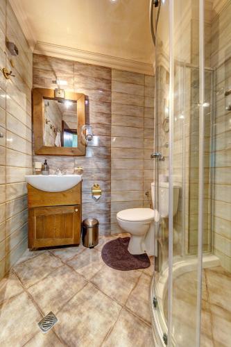 a bathroom with a toilet and a sink and a shower at Апартамент Борчето Forest Glade- Pamporovo in Pamporovo