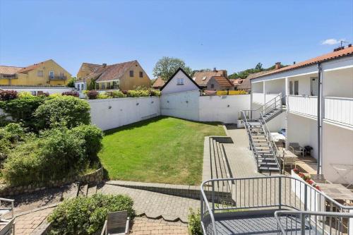 a backyard of a house with a lawn at 5633-Gudhjem-Kirkevej-10-lejl-19 in Gudhjem