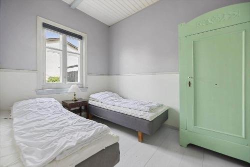 a bedroom with two beds and a window at 6746-Hasle-Krakvej-3 in Hasle