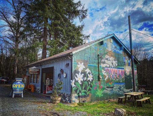 a building with graffiti on the side of it at Emmons Suite at Ashford Lodge: Hot Tub, Projector! in Ashford