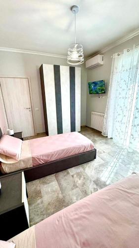 a bedroom with two beds in a room at Tor Vergata Smart Living in Rome