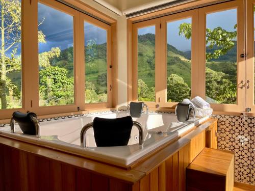 a large bath room with a large tub with windows at Hotel Lago Valdivia in Jardin