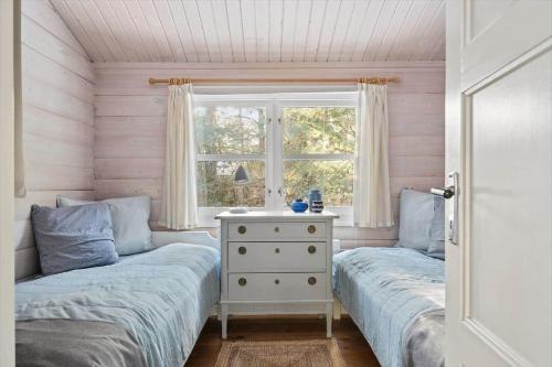 two beds in a room with a window at 3707-Nexo-Sondervej-3 in Neksø