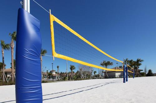 a blue and yellow volleyball net in the sand at Champion gate townhome in Kissimmee