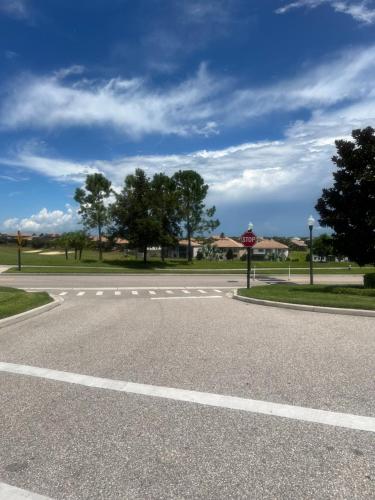 an empty street with a stop sign on the road at Champion gate townhome in Kissimmee