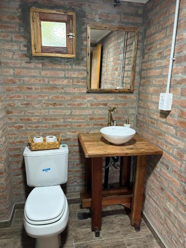 a bathroom with a toilet and a sink at Hosteria Miyazato Inn in El Calafate