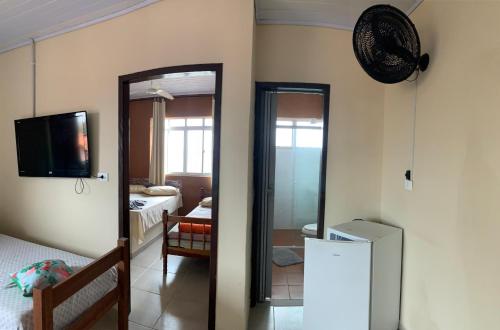 a room with a mirror and a room with a refrigerator at Pousada Fênix,com piscina -250 METROS DA PRAIA in Pontal do Paraná