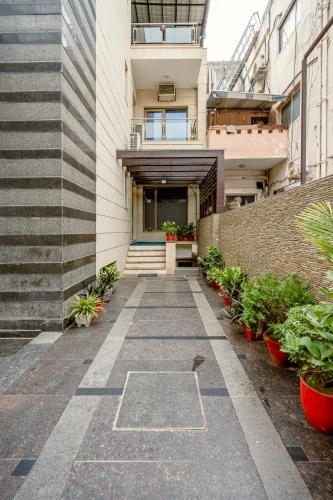 a walkway leading to the entrance of a building at Galleria Inn -Galleria Market & Golf Course in Gurgaon