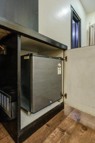 a kitchen with a large metal door in a room at Galleria Inn -Galleria Market & Golf Course in Gurgaon