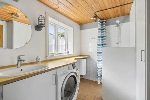 a bathroom with a washing machine and a sink at 5617-Svaneke-Per-Sorens-Gade-2 in Svaneke