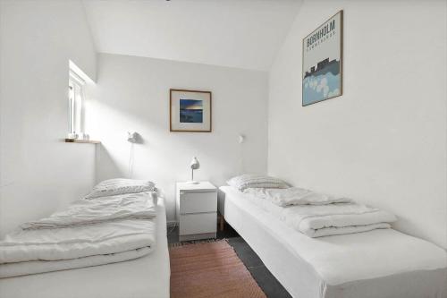 two beds in a room with white walls at 6663-Allinge-Stien-4 in Allinge