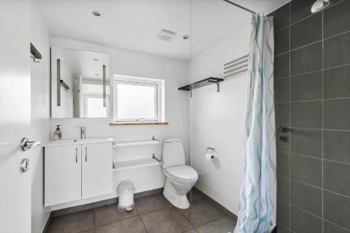 a bathroom with a toilet and a sink and a shower at 6663-Allinge-Stien-4 in Allinge