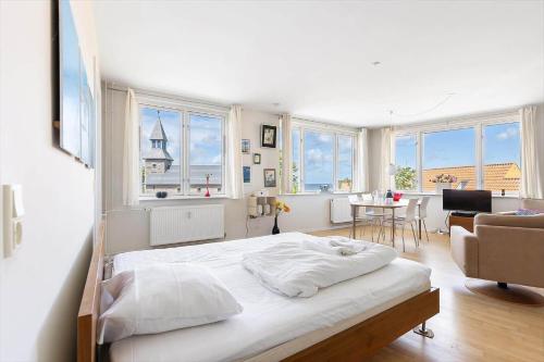 a bedroom with a bed and a living room at 5642-Gudhjem-Kirkevej-10-lejl-5 in Gudhjem