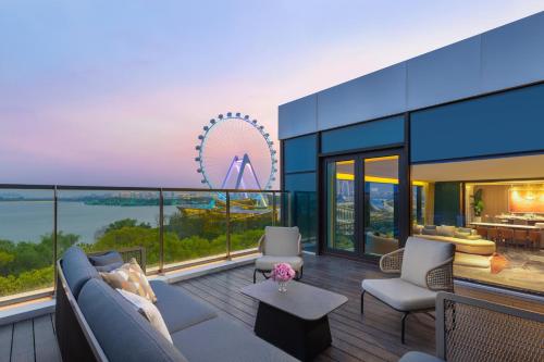 a living room with a view of the ferris wheel at Hotel Indigo Suzhou Jinji Lake by IHG in Suzhou