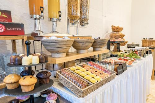a buffet with bread and pastries on a table at Hotel Domschatz in Quedlinburg