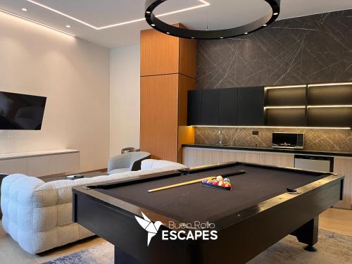 a living room with a pool table and a couch at Luxury High-Floor 3 Bedroom Apartment FREE Pool & Gym in Guatemala
