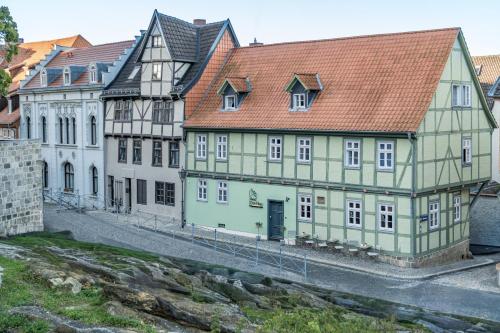 a group of older buildings in a city at Hotel Domschatz in Quedlinburg