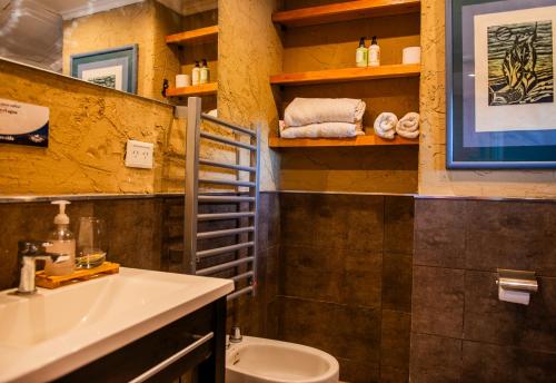a bathroom with a sink and a toilet in it at Equs Posada de Campo in San Carlos de Bariloche