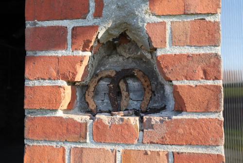 a brick wall with a metal object in it at Stacja Binino 