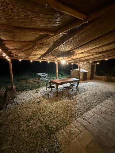 a patio with a table and chairs under a roof at Le Tre Aie in San Giovanni a Piro