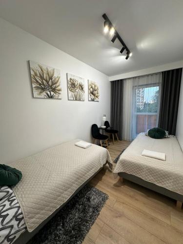 Ένα ή περισσότερα κρεβάτια σε δωμάτιο στο Apartament GB przy PCK 5 z bezpłatnym parkingiem by Gingerbread Apartments
