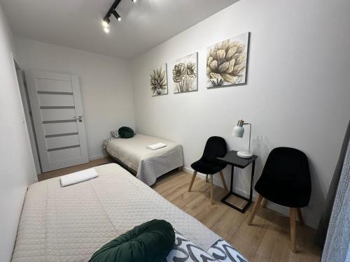 Ένα ή περισσότερα κρεβάτια σε δωμάτιο στο Apartament GB przy PCK 5 z bezpłatnym parkingiem by Gingerbread Apartments