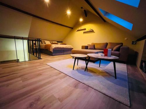 a living room with a couch and a table at De Poverleute in Kortrijk