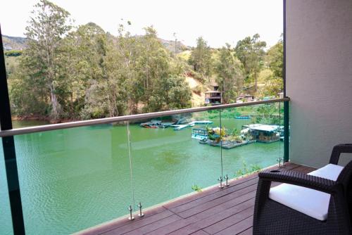 a balcony with a view of a river with boats at Hotel Nova El Peñol in El Peñol