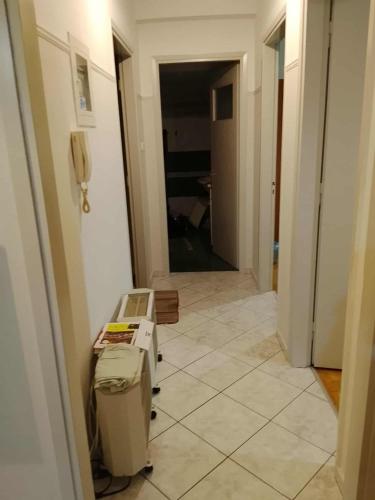 a hallway with a tile floor and a room with a printer at Savelona's Guest Appartment in Agrinion