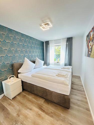 a bedroom with a large bed in a room at Fewo am Tüllinghof in Lüdinghausen