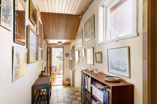 a hallway with many pictures on the walls at 5634-Svaneke-Bolshavn-29-A in Svaneke