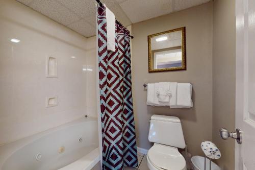 a bathroom with a toilet and a tub and a sink at Pigeon Forge Paradise in Pigeon Forge