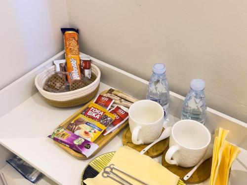 a kitchen counter with two cups and other items on it at Osheba in Qabāʼ