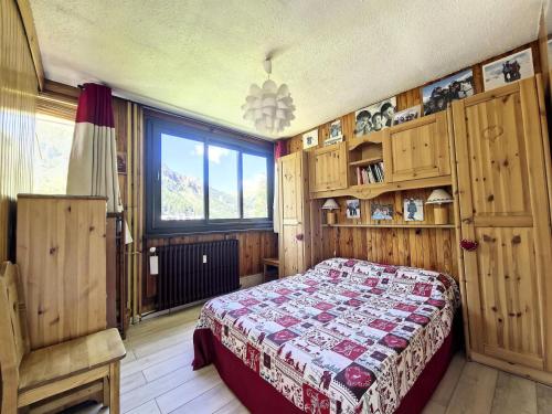 a bedroom with a bed and a large window at Residence De L'isere - Grand appartement dans le centre MAE-1713 in Val dʼIsère