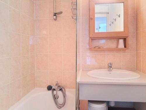a bathroom with a sink and a bath tub at Résidence Pierre Et Vacances La Daille - appartement proche pistes et commerces MAE-1803 in Le Crêt