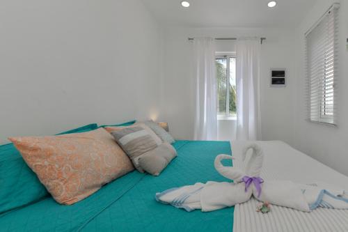 a bedroom with a bed with towels on it at Hotel experience with daily housekeeping and laundry in Oranjestad
