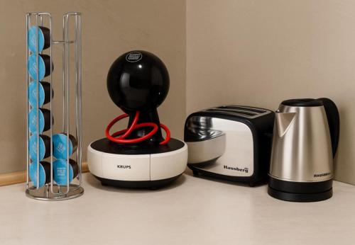 a kitchen counter with a blender and a coffee maker at Fit Mornings Apartment in Skopje
