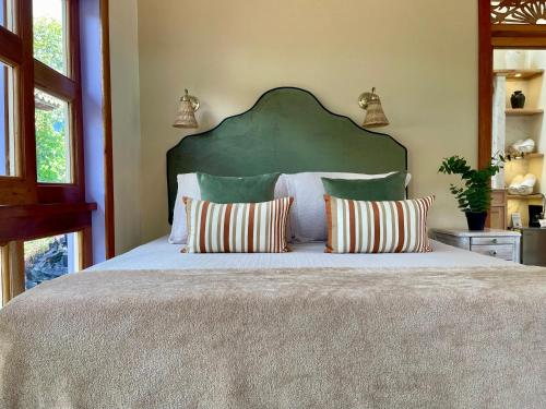 a bedroom with a large bed with two pillows at Hotel Lago Valdivia in Jardin