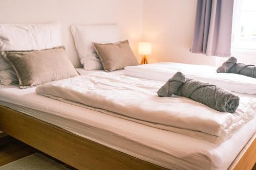a large bed with two pillows on it at Luxury Apartments Pivovarské domy in Hradec Králové