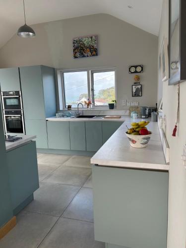 a kitchen with a counter with a bowl of fruit on it at Cois Cuan in Ballynagaul