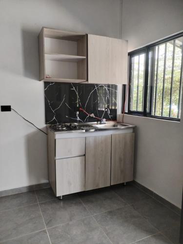 a kitchen with a sink and a counter top at JYM apartaestudios Doradal in Doradal