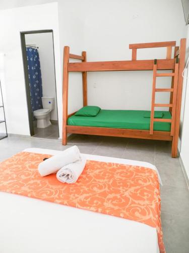 a bedroom with two bunk beds and a toilet at JYM apartaestudios Doradal in Doradal