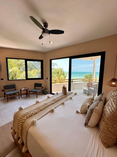 a bedroom with a large bed with a view of the ocean at Ana y Jose Hotel & Beach Club Holbox in Holbox Island