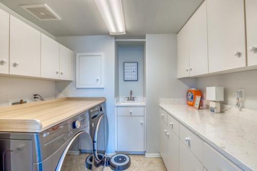 a kitchen with white cabinets and a dishwasher at Lakefront Oasis at Lake Stevens in Lake Stevens