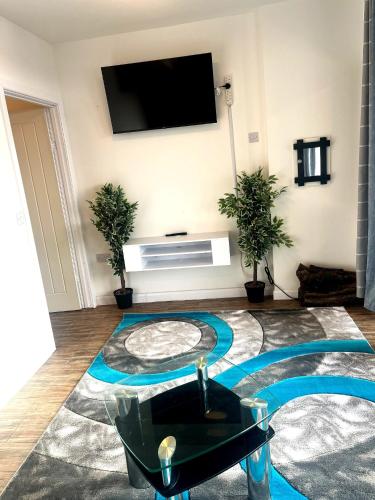 a living room with a flat screen tv on the wall at Bacton Coastal Retreat in Bacton
