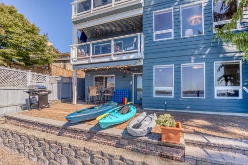 a blue house with three kayaks in front of it at Lakefront Oasis at Lake Stevens in Lake Stevens