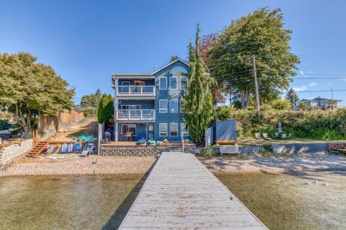 a blue house on the shore of a body of water at Lakefront Oasis at Lake Stevens in Lake Stevens